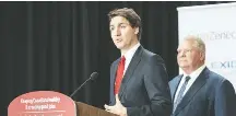  ?? FRANK GUNN/ASSOCIATED PRESS ?? Canadian Prime Minister Justin Trudeau speaks about the ban, as Ontario Premier Doug Ford listens, in Mississaug­a, Ontario.