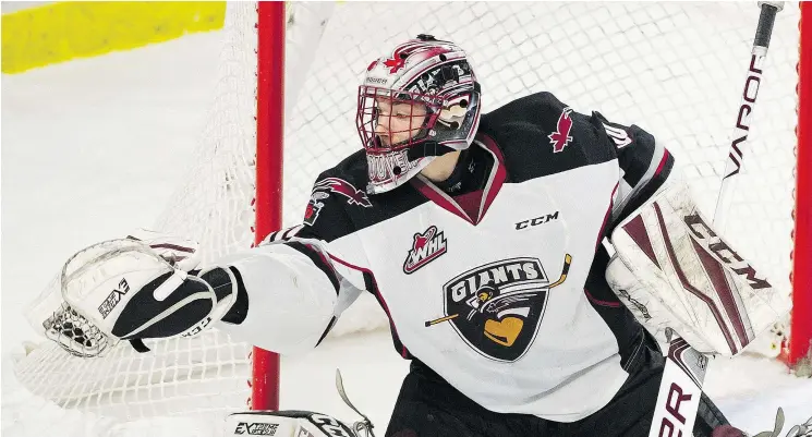  ?? GERRY KAHRMANN/PNG ?? Vancouver Giants goalie David Tendeck makes a glove save against the Kelowna Rockets in Langley on Saturday.