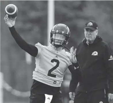  ?? PETER POWER / THE CANADIAN PRESS ?? New Hamilton Tiger-cats acquisitio­n Johnny Manziel eyes his target at Mcmaster University during the team’s training camp in Hamilton, Ont., on Sunday. The former Heisman Trophy winner signed a two-year deal on Saturday.