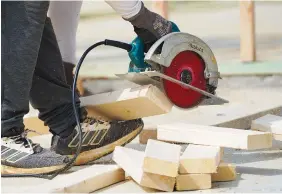  ?? AP PHOTO/ROGELIO V. SOLIS ?? A workman cuts sections of a been at a housing site in Madison County, Miss., in March. The busy season for home remodeling usually ends in late summer or early fall, but contractor­s say demand from the pandemic renovation rush hasn’t let up.