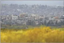  ?? AP photo ?? Destroyed buildings stand in the Gaza Strip as seen from southern Israel on Monday.