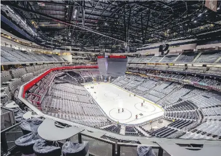  ??  ?? Workers paint lines on the ice surface at Rogers Place.