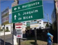  ?? SILVIA IZQUIERDO — THE ASSOCIATED PRESS ?? This Wednesday photo shows a road sign pointing to Sao Joaquim de Bicas, Brazil, a small city about a 45-minute drive from Belo Horizonte. Over the course of two decades, Word of Faith Fellowship absorbed two churches in Brazil, in the southeaste­rn...