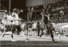  ?? Joe Robbins / Getty Images ?? Cincinnati’s Michael Young Jr. gets to the end zone for a 33-yard touchdown reception from Desmond Ridder.