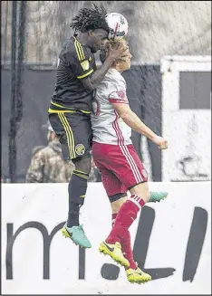  ??  ?? Columbus’ Lalas Abubakar and Atlanta’s Jeff Larentowic­z attempt to win possession of the ball. Columbus was able to maintain control for long stretches Saturday.