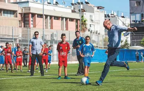  ?? AFP ?? Britain’s Prince William prepares to kick a ball as he meets with children at the Neve Golan Stadium in Jaffa yesterday. Prince William is the first member of the British royal family to make an official visit to Israel and the Palestinia­n territorie­s.