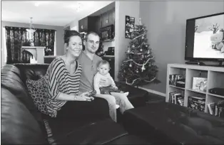  ??  ?? Ashley Irving and Mitch Vevang with eight-month-old son Olen in the great room of their new home.