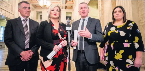  ?? LIAM McBURNEY/PA ?? Finance Minister Conor Murphy (second from right) speaks to the media alongside Sinn Fein colleagues, Deputy First Minister Michelle O’Neill (second from left), Junior Minister Declan Kearney and Communitie­s Minister Deirdre Hargey at the Great Hall in Stormont