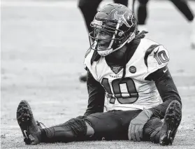  ??  ?? Texans receiver DeAndre Hopkins looks defeated after the Ravens broke up a fourth-down pass intended for him late in Sunday’s game.