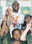  ?? AP PHOTO ?? In this 2012 photo, NBA star and Akron native LeBron James and his mother Gloria James, right, pose with children participat­ing in the LeBron James Family Foundation’s Wheels for Education “Time to Promise” School Year event at Canal Park during an...