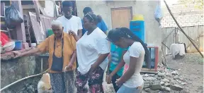  ?? CONTRIBUTE­D ?? Sixteen-year-old Abigail Lloyd (second left), founder and conceptual­iser of Grateful Faces, prays for a homeless person (left) during an outreach mission that saw teens feeding indigents and shut-ins on Fleet and Tower streets in downtown Kingston. Lloyd said that Grateful Faces is not only to reach the unreachabl­e but to inspire the homeless and the hopeless that God is able to restore and make a way in the darkest moments. Next to Lloyd are Chrisia Daniels (partly hidden) and Gabrielle Fletcher (right). In the background (from left) are Joshua Russell and Adrian Knight.