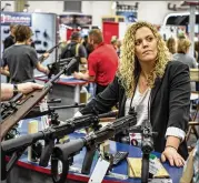  ?? ASHLEY GILBERTSON / NEW YORK TIMES ?? Kara Boesenberg, 28, vice president of sales and marketing for gun maker Inland Manufactur­ing, attends the National Rifle Associatio­n convention May 5 with about 75,000 NRA members.