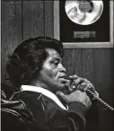  ?? AJC 1980 ?? James Brown (in his Augusta office) did not have much initial success selling records but built his reputation with legendary live performanc­es.