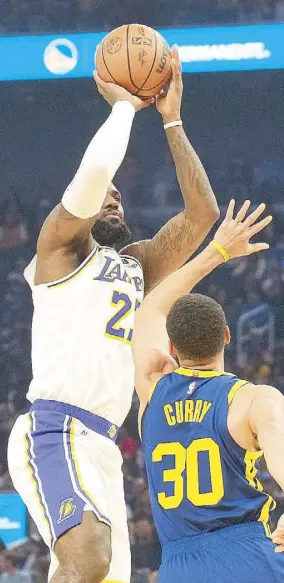  ?? REUTERS ?? Los Angeles Lakers forward LeBron James shoots against Golden State Warriors guard Stephen Curry during the second quarter at Chase Center.