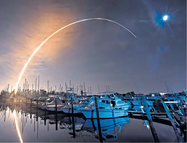  ?? ?? Nasa’s new Moon rocket lifts off from the Kennedy Space Centre in Cape Canaveral yesterday and can be seen over Florida’s Harbor Town marina on Merritt Island with its destinatio­n in the far distance