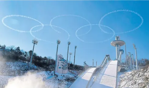  ??  ?? PLAYING THE GAME: Members of the South Korean air force Black Eagle aerobatic team perform above the ski jump venue of the Pyeongchan­g 2018 Winter Olympics.