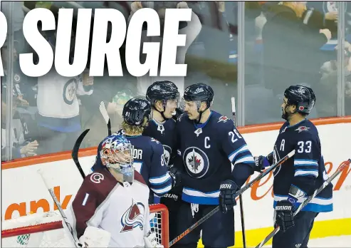  ?? —CP ?? Jets captain Blake Wheeler celebrates a power-play goal with teammates during Friday’s win over Colorado.