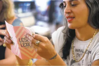  ?? Photos by Paul Chinn / The Chronicle ?? Finding the right words: Stevie Ann DePaola flips through the third edition of the Lesbian Lexicon at Pegasus Books in Berkeley. The fourth edition is being released Saturday, July 27. Lesbian Lexicon Art Party: 6-10p.m. Saturday, July 27. $5$20, sliding scale, for a copy of the Lesbian Lexicon. Hit Gallery, 2740 16th St., S.F. All proceeds from this zine release go to the Transgende­r Gender-variant and Intersex Justice Project.