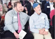  ?? Hearst Connecticu­t Media file photo ?? Thayer Baldwin, right, and Chris Baldwin listen to speeches during the dedication and ribbon cutting for Geller Commons in Hamden on April 18, 2016.