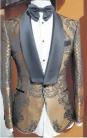  ??  ?? An elegant black and gold silk tuxedo jacket