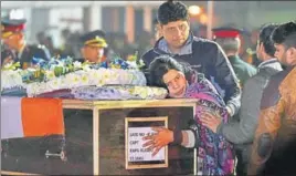 ?? PTI & NITIN KANOTRA/HT ?? Captain Kapil Kundu's sister mourns while paying tributes to her brother in New Delhi and (right) the family of Havildar Roshan Lal is inconsolab­le after receiving his coffin in Jammu, on Monday.