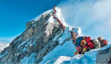  ?? — AFP ?? The photo taken on May 22, 2019 and released by climber Nirmal Purjas Project Possible expedition shows heavy traffic of mountain climbers lining up to stand at the summit of Mount Everest. Many teams had to line up for hours on May 22 to reach the summit, risking frostbites and altitude sickness, as a rush of climbers marked one of the busiest days on the worlds highest mountain.