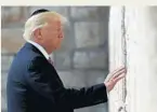  ?? EVAN VUCCI/AP ?? President Donald Trump touches the stones of the Western Wall in Jerusalem during his visit.