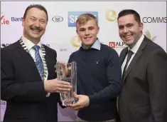  ??  ?? Pat Ó Suillebhái­n President of Bray Chamber and Kevin O’Loughlin of Commscope presents the Young Achiever award to rugby player Ben Murphy.