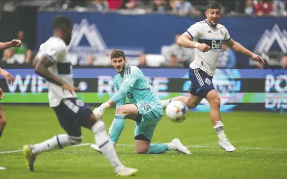  ?? DARRYL DYCK/THE CANADIAN PRESS ?? Toronto FC goalie Alex Bono watches as Whitecaps' Tosaint Ricketts, front left, scores the game's only goal after receiving a pass from Lucas Cavallini, right.