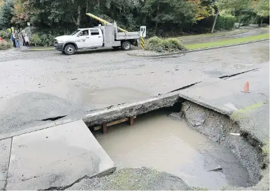  ??  ?? Crews work to fix a water main that burst on Royal Oak Drive in October 2017.