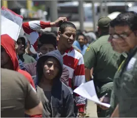  ?? SALVADOR GONZALEZ — THE ASSOCIATED PRESS ?? United States Border Patrol officers return a group of migrants back to the Mexico side of the border as Mexican immigratio­n officials check the list, in Nuevo Laredo, Mexico.