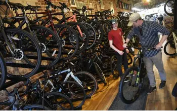  ?? Helen H. Richardson, The Denver Post ?? Salesman Jake Wade helps a customer at Peak Cycles on March 28.