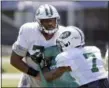  ?? SETH WENIG — THE ASSOCIATED PRESS FILE ?? In this Wednesday file photo,New York Jets’ Darius James, left, works with Tre McBride during practice at the NFL football team’s training camp in Florham Park, N.J.