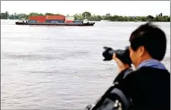  ?? HENG CHIVOAN ?? A cargo ship transports goods to internatio­nal markets on the Mekong River in the past.