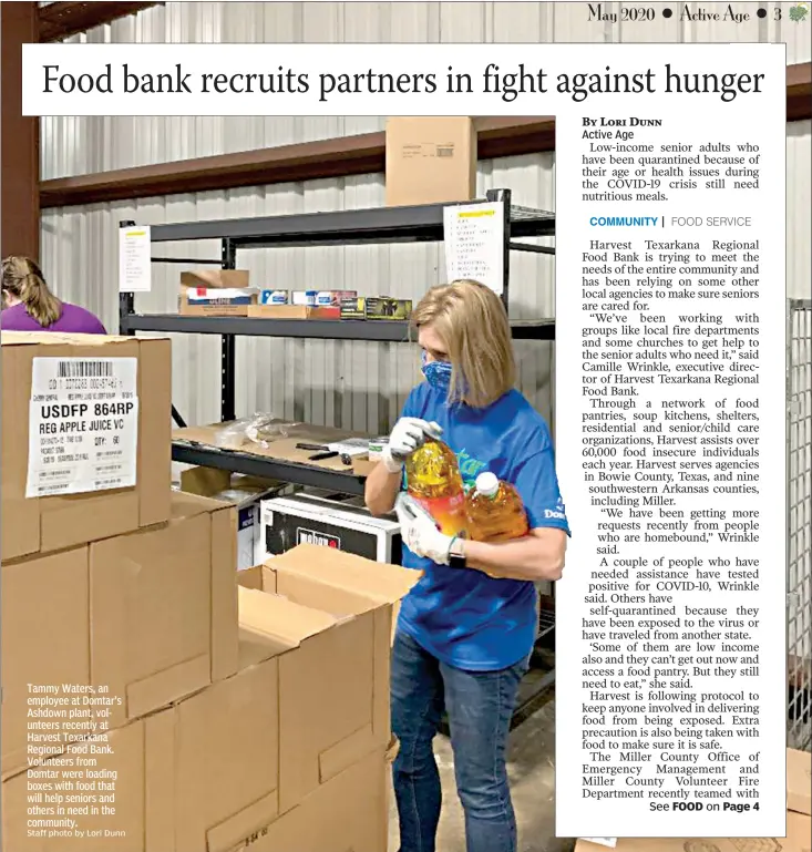  ?? Staff photo by Lori Dunn ?? Tammy Waters, an employee at Domtar's Ashdown plant, volunteers recently at Harvest Texarkana Regional Food Bank. Volunteers from Domtar were loading boxes with food that will help seniors and others in need in the community.