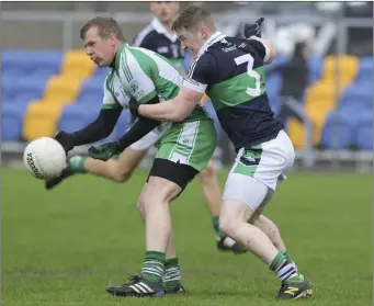  ??  ?? Baltinglas­s full-forward Sean O’Brien gets his hand passs away despite the efforts of Bray’s Adam Benson.