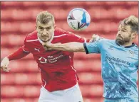  ?? PICTURE: BRUCE ROLLINSON ?? BATTLER: Polish defender Michal Helik, left, is relishing the challenge of establishi­ng himself at Barnsley.