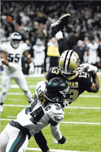  ?? Bill Feig The Associated Press ?? Saints wide receiver Michael Thomas pulls in a 2-yard touchdown catch against Eagles cornerback Cre’von Leblanc in Sunday’s NFC divisional-round game in New Orleans.