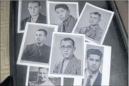  ?? ?? Copies of photos of Holocaust survivors are laid out during a reunion for their families in East Brunswick, N.J., on Sunday. Anna Salton Eisen found the old pictures of Jewish prisoners who survived the Holocaust in a folder her late father, George Lucius Salton, kept most of his life.