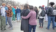  ?? HYOUNG CHANG/ AP ?? Isabella DeJoseph, 15, center left, is embraced by her mother Alana as they leave East High School after a school shooting in Denver on Wednesday.