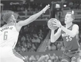  ?? NICK WASS/AP ?? Heat guard Duncan Robinson (55) prepares to shoot against Wizards forward Troy Brown Jr. (6) during the first half of a game on March 8 in Washington.