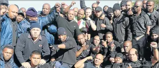  ?? Picture: BHONGO JACOB ?? FATHERS, HUSBANDS, SONS: Cashin-transit security guards march to the East London police station to hand over a list of demands and highlight safety concerns in their industry