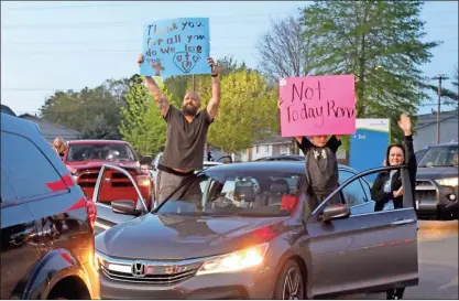  ?? Daniel Bell ?? People hold signs during the community gathering at the hospital on Thursday.