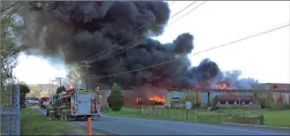  ??  ?? Above: Barwick Mills exploded into flames on Saturday, Nov. 14, 2015, belching billows of black smoke, visible for miles. Below: Today the site in LaFayette is a heap of bricks and twisted metal — and infused with asbestos. Messenger photos/Josh...