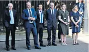  ??  ?? Team May outside No10 as she gives her speech. From left: Robbie Gibb, director of communicat­ions; Gavin Barwell, chief of staff; Andrew Bowie, the PM’S parliament­ary private secretary; Mrs May’s husband, Philip; Natasha Adkins, special adviser; Victoria Busby, senior official