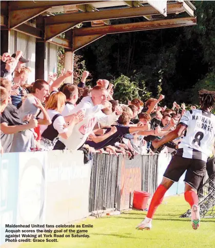  ?? ?? Maidenhead United fans celebrate as Emile Acquah scores the only goal of the game against Woking at York Road on Saturday. Photo credit: Grace Scott.
