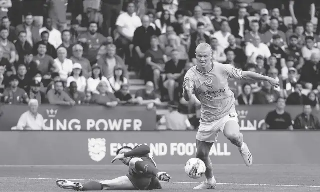  ?? AP ?? MANCHESTER City’s Erling Haaland (right) beats the challenge posted by Liverpool’s Andrew Robertson during their FA Community Shield match at the the King Power Stadium in Leicester, England, recently.