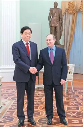  ?? BAI XUEQI / XINHUA ?? Russian President Vladimir Putin meets Li Zhanshu, director of the General Office of the Communist Party of China Central Committee, at the Kremlin in Moscow on Wednesday.