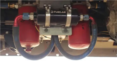  ??  ??  After diesel gravity-feeds through a Beans Diesel Performanc­e sump in the factory tank, it makes its way to this basic competitio­n fuel system from Irate Diesel Performanc­e. Combined with a regulated return system from Diesel Innovation­s, the Fuelab 41401 pump sends fuel to the rear of each head, and an adjustable Fuelab regulator keeps pressure set to 70 psi.