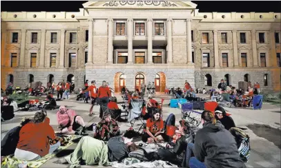  ?? Matt York ?? The Associated Press Teachers camp out Thursday morning at the Capitol in Phoenix as legislator­s debate a budget proposal giving educators raises.